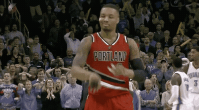 A Basketball Player Wearing A Red Portland Jersey Is Dancing In Front Of A Crowd GIF