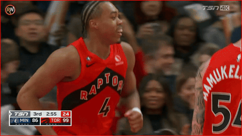 A Basketball Player Wearing A Red Raptors Jersey Is Celebrating GIF