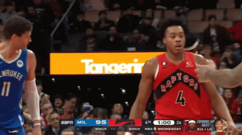A Basketball Player Wearing A Red Raptors Jersey Stands Next To Another Player GIF