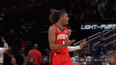 A Basketball Player Wearing A Red Rockets Jersey Celebrates GIF