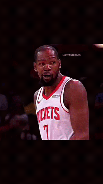 A Basketball Player Wearing A Rockets Jersey Looks At The Camera GIF