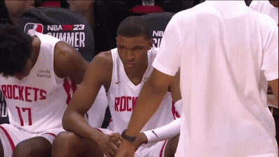 A Basketball Player Wearing A Rockets Jersey Talks To Another Player GIF