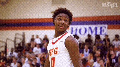 A Basketball Player Wearing A Sfg Jersey Stands In Front Of A Crowd GIF