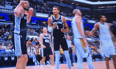 A Basketball Player Wearing A Spurs Jersey Celebrates GIF