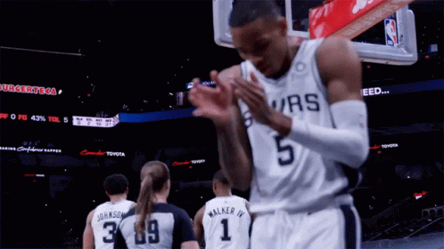A Basketball Player Wearing A Spurs Jersey Is Clapping GIF