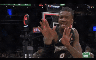 A Basketball Player Wearing A Timberwolves Jersey Is Clapping GIF