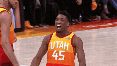 A Basketball Player Wearing A Utah Jersey Is Laughing On The Court GIF