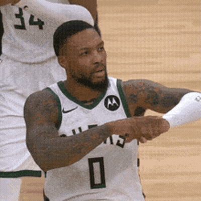 A Basketball Player Wearing A White And Green Jersey With The Number 0 On It . GIF