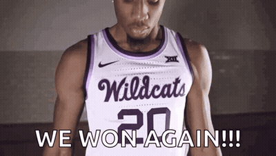 A Basketball Player Wearing A White And Purple Wildcats Jersey GIF