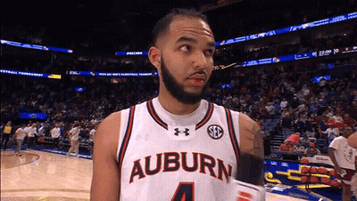 A Basketball Player Wearing A White Jersey That Says Auburn 4 GIF