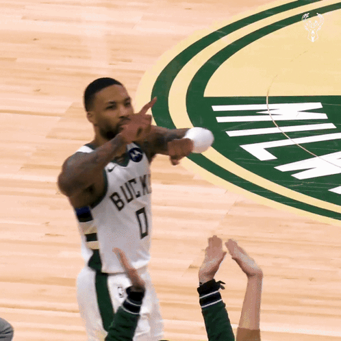 A Basketball Player Wearing A White Jersey That Says Bucks 0 GIF