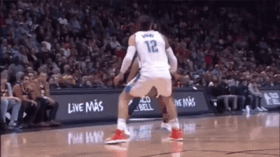 A Basketball Player Wearing A White Jersey With The Number 12 On It GIF