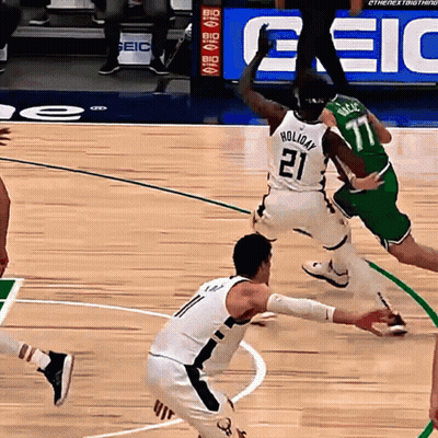A Basketball Player Wearing A White Jersey With The Number 21 On It GIF
