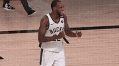A Basketball Player Wearing A White Jersey With The Word Bucks On It Is Standing On A Court . GIF
