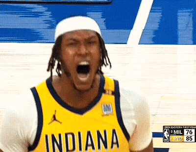 A Basketball Player Wearing A Yellow Indiana Jersey Is Yelling GIF