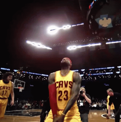 A Basketball Player Wearing A Yellow Jersey That Says Cavs 23 On It GIF