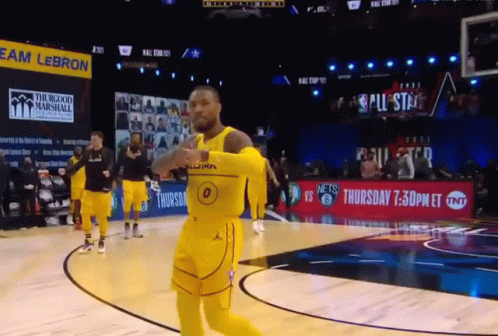 A Basketball Player Wearing A Yellow Jersey With The Number 0 On It Is Running On The Court GIF