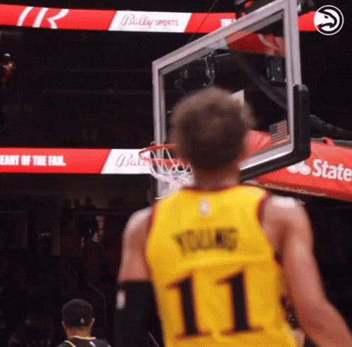 A Basketball Player Wearing A Yellow Jersey With The Number 11 GIF