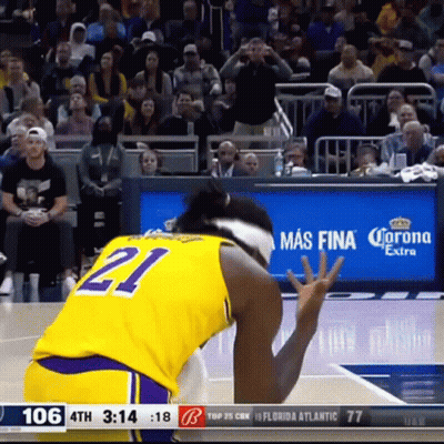 A Basketball Player Wearing A Yellow Jersey With The Number 21 GIF
