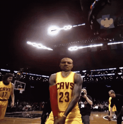 A Basketball Player Wearing A Yellow Jersey With The Number 23 GIF
