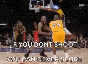 A Basketball Player Wearing A Yellow Jersey With The Number 24 On It Is Trying To Shoot A Basketball At Another Player . GIF
