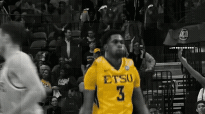 A Basketball Player Wearing A Yellow Jersey With The Number 3 GIF