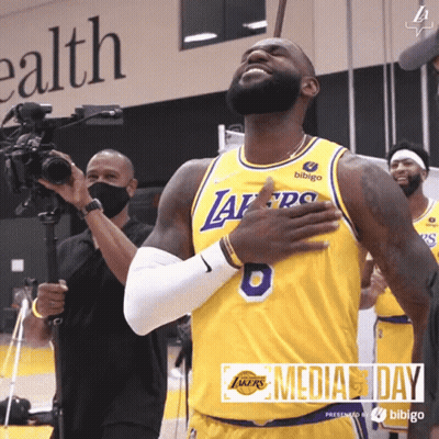 A Basketball Player Wearing A Yellow Jersey With The Number 8 On It GIF