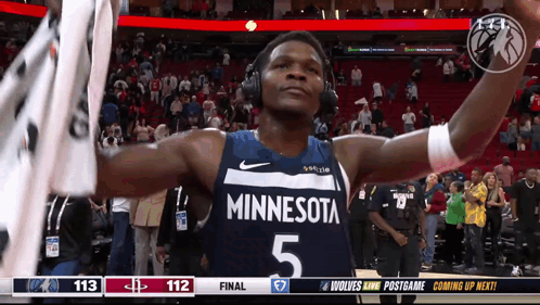 A Basketball Player Wearing Headphones And A Minnesota Uniform GIF