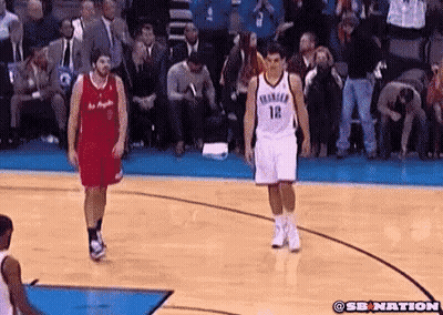 A Basketball Player Wearing Number 12 Stands On The Court GIF