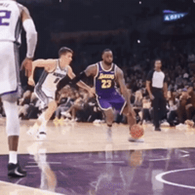 A Basketball Player Wearing Number 23 Is Dribbling The Ball GIF