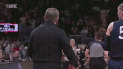 A Basketball Player Wearing Number 24 Is Being Helped By A Man GIF