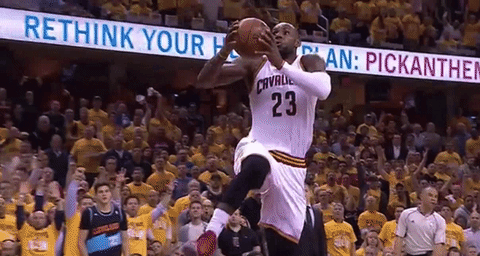 A Basketball Player Wearing The Number 23 Jumps In The Air To Catch The Ball GIF