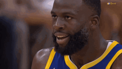 A Basketball Player With A Beard Is Making A Funny Face With His Mouth Open . GIF
