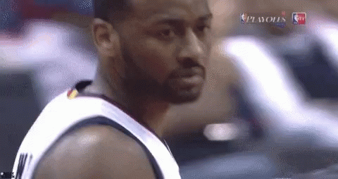 A Basketball Player With A Beard Is Standing In Front Of A Car . GIF