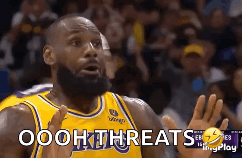 A Basketball Player With A Beard Is Wearing A Yellow Jersey With The Word Ooh Threats On It . GIF