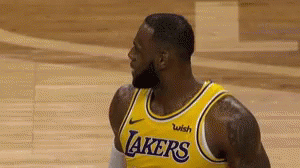 A Basketball Player With A Beard Is Wearing A Yellow Lakers Jersey . GIF