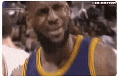A Basketball Player With A Beard Wearing A Blue And Gold Jersey Is Smiling . GIF
