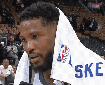 A Basketball Player With A Towel Wrapped Around His Head And The Word Ske On His Shirt GIF