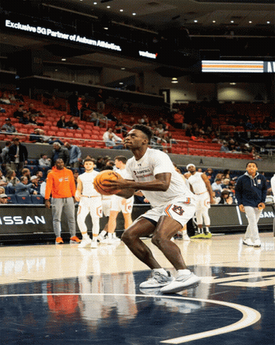 A Basketball Player With Auburn On His Shorts Holds The Ball GIF
