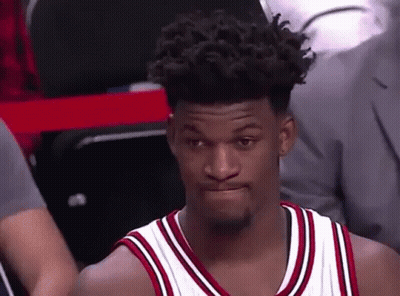 A Basketball Player With Curly Hair Is Sitting In The Stands During A Game And Making A Funny Face . GIF