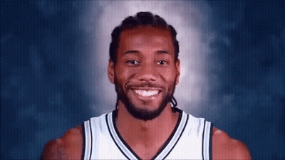 A Basketball Player With Dreadlocks And A Beard Smiles For The Camera . GIF