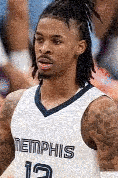 A Basketball Player With Dreadlocks Is Wearing A Jersey That Says Memphis GIF