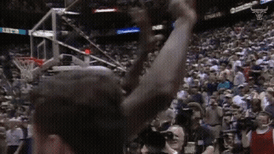 A Basketball Player With His Arms In The Air In Front Of A Crowd With A Scoreboard That Says 11:52 GIF