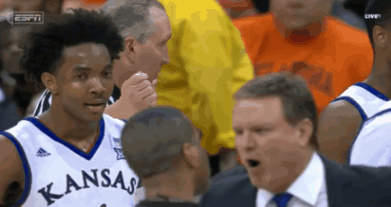A Basketball Player With Kansas On His Jersey Talks To His Coach GIF