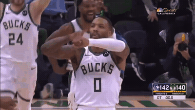 A Basketball Player With The Number 0 On His Jersey Is Giving A High Five To Another Player . GIF