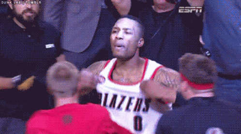 A Basketball Player With The Number 0 On His Jersey Is Surrounded By Fans GIF