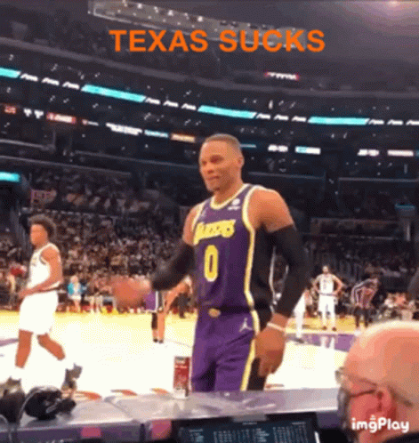 A Basketball Player With The Number 0 On His Jersey Stands In Front Of A Crowd At A Basketball Game GIF