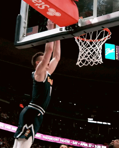 A Basketball Player With The Number 1 On His Jersey Jumps Into The Net GIF