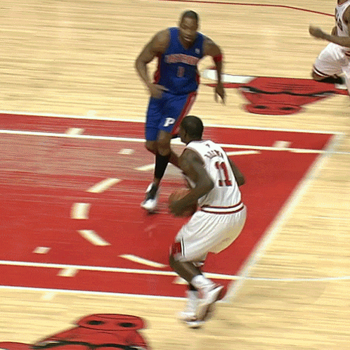 A Basketball Player With The Number 11 On His Jersey Is Dribbling The Ball GIF