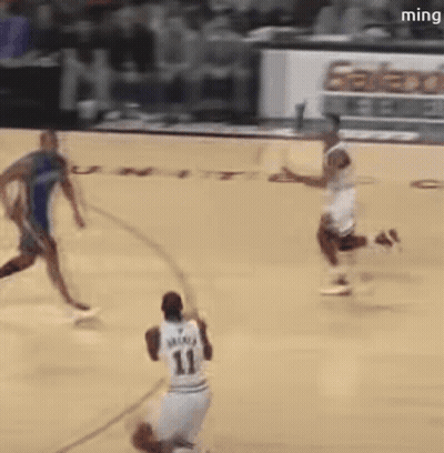 A Basketball Player With The Number 11 On His Jersey Is Dribbling The Ball GIF